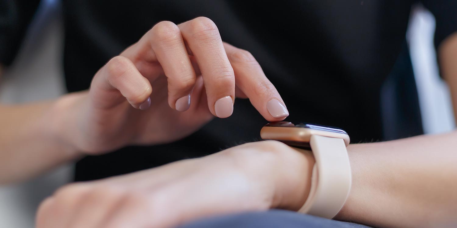 Close-up photo of a person interacting with their smart watch