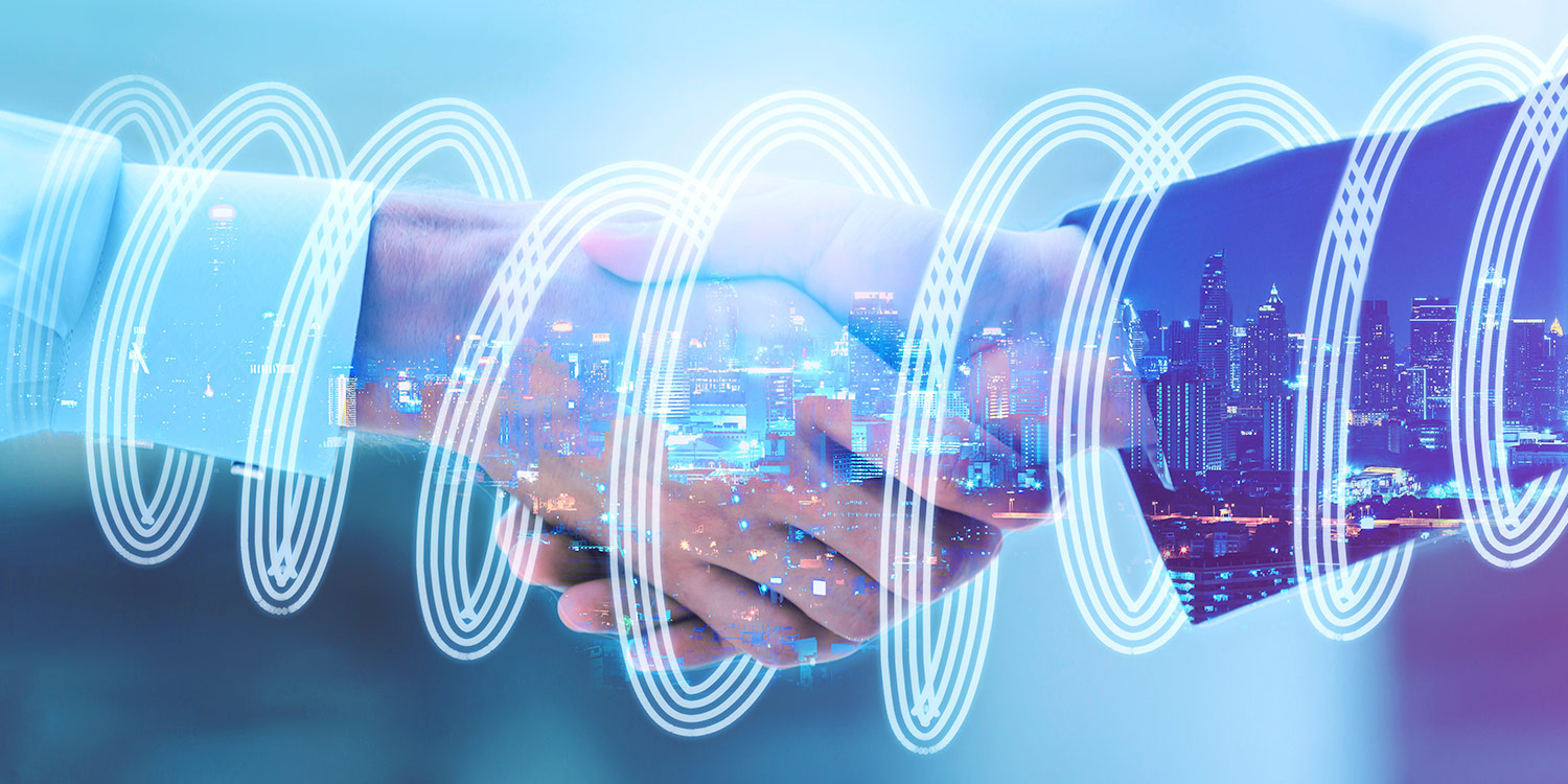 Photograph of a handshake with illuminated overlay of lines surrounding the hands